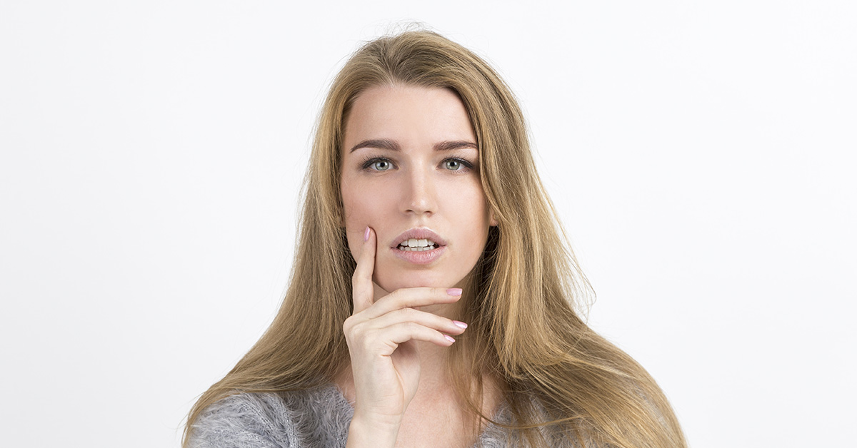 woman with finger on her face