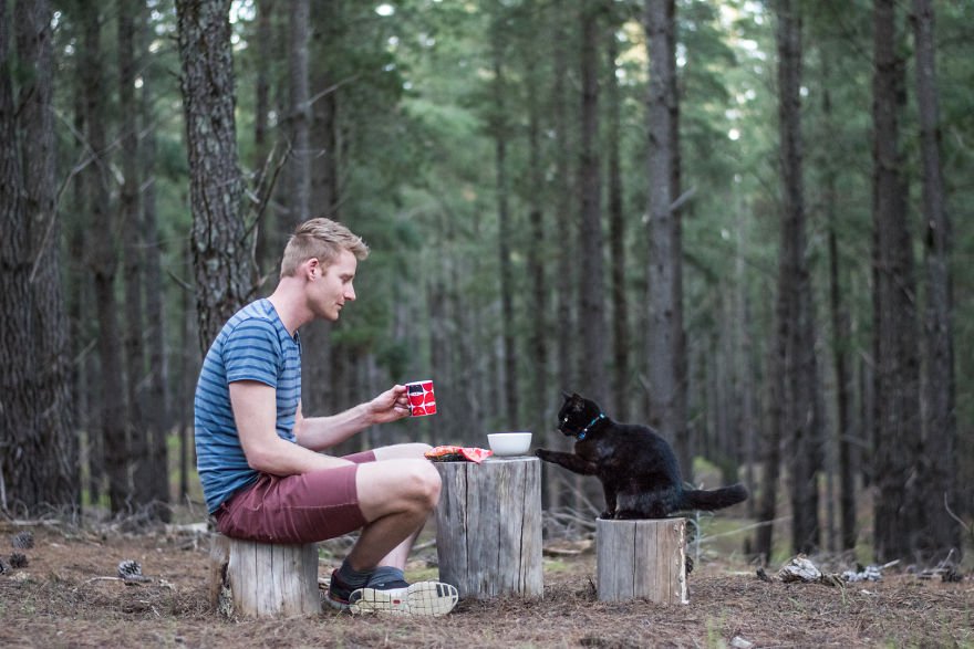 man in the forest with his cat