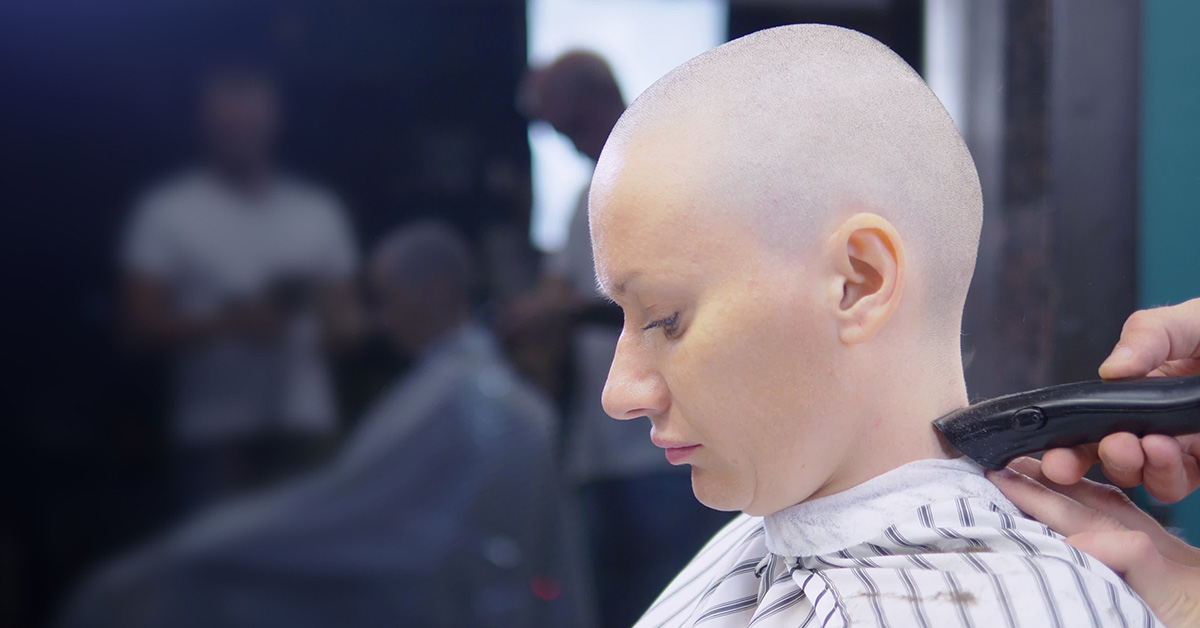 woman getting her head shaved