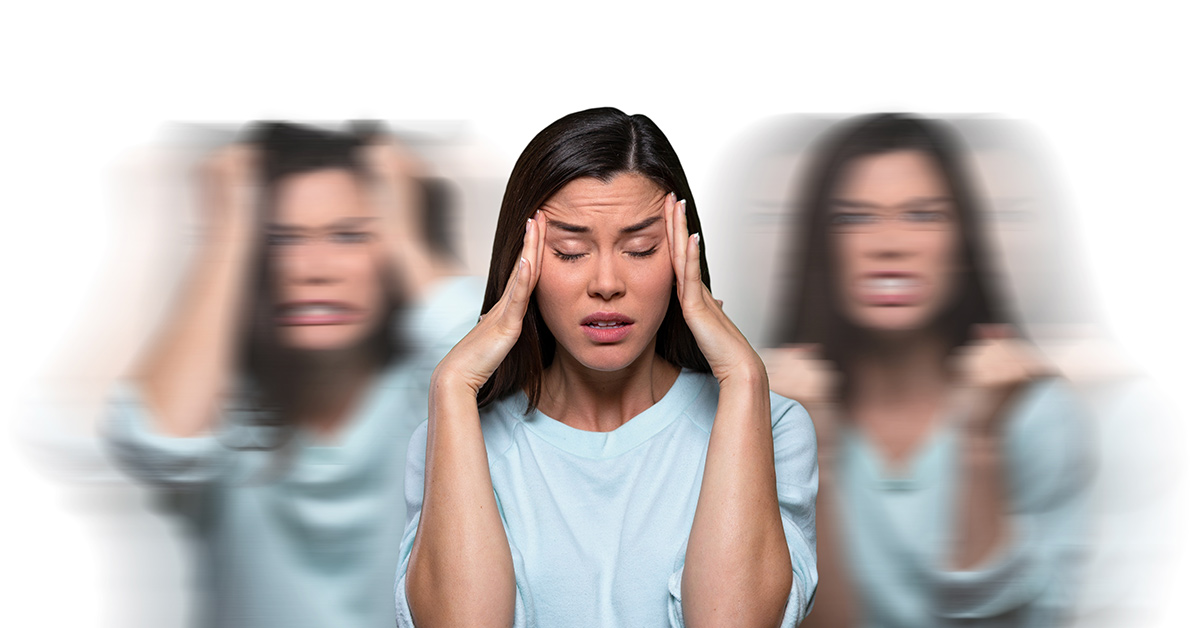 woman holding her head struggling with inner conflict