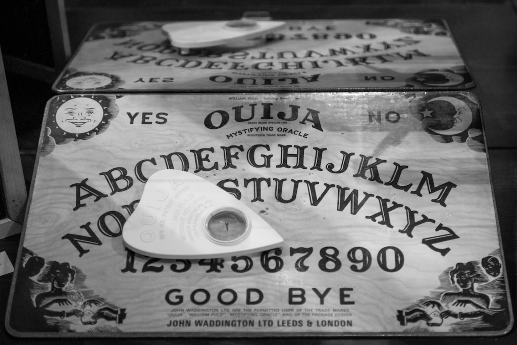 Black and white mage of ouija board and planchette