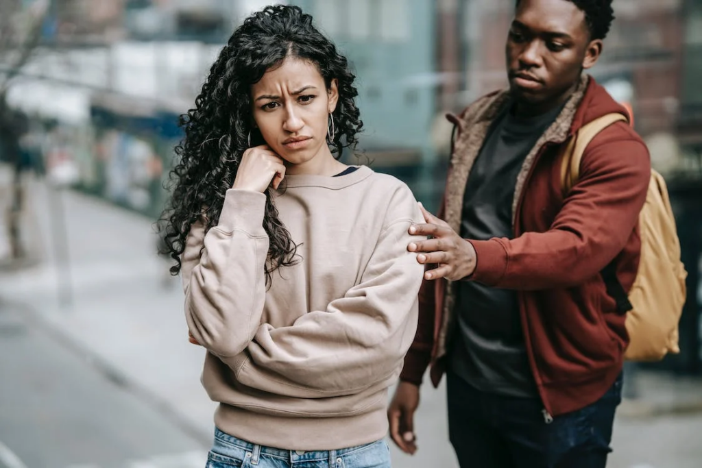 couple arguing with each other in street
