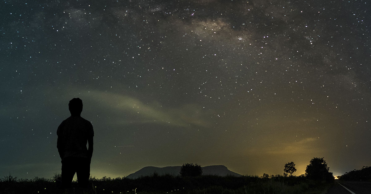 silhouette of person stargazing