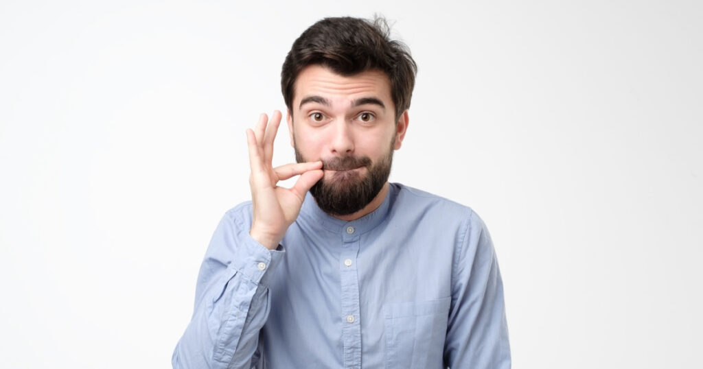 man in glasses, making gesture with hand, zipping lips