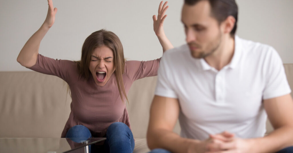 Young woman yelling at boyfriend in hysterics