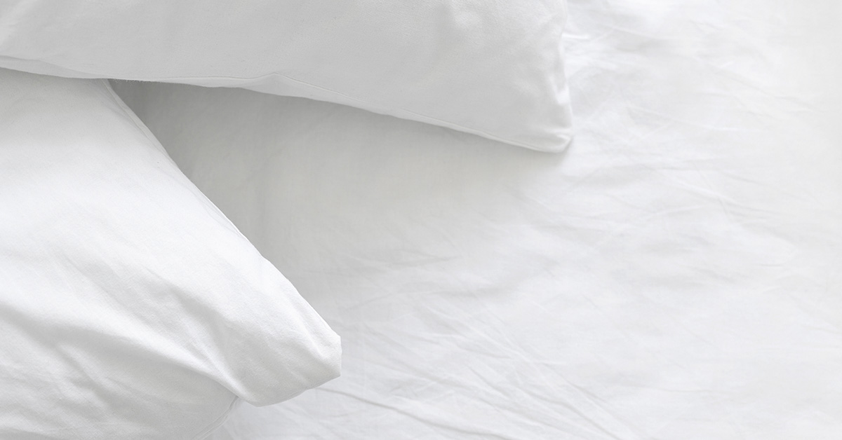 white pillows and sheets on bed