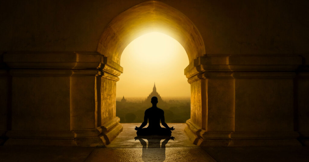 Man with yoga pose in buddhist temple
