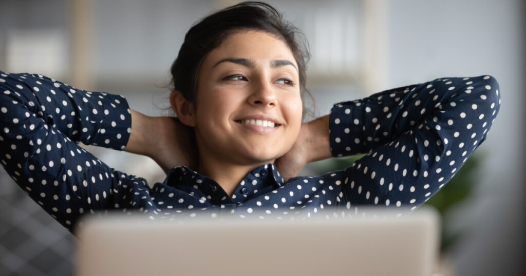 Happy satisfied indian woman rest at home office