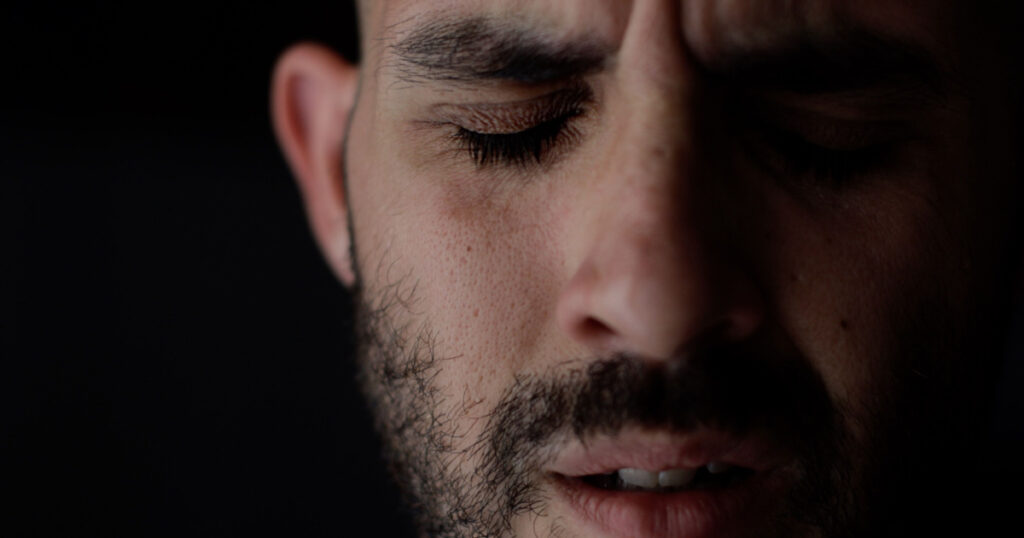 Extreme close up portrait of sad and depressed man. Caucasian man crying face. High quality photo
