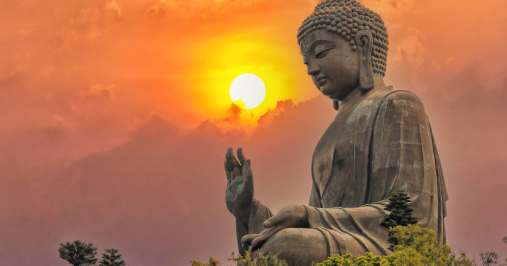 Big bronze Amoghasiddhi Buddha statue called Tian Tan Buddha with sunset sky at Po Lin Monastery Ngong Ping in Lantau Island famous tourist destination in Hong Kong China
