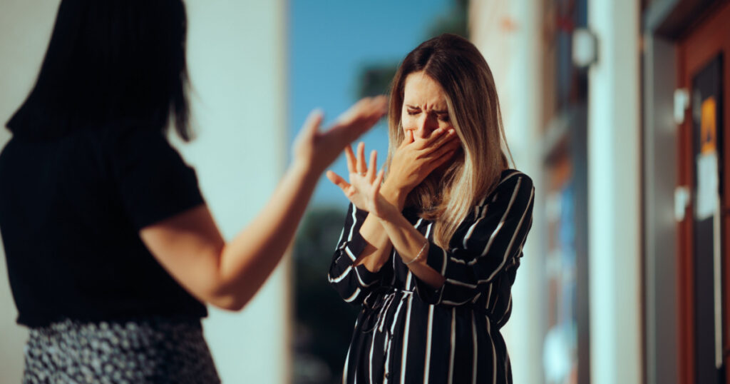 Woman Crying Fighting with Her Best Friend Outdoors. Unhappy emotional girl disagreeing with her sister

