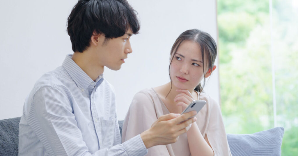 Asian young couple looking at a smartphone
