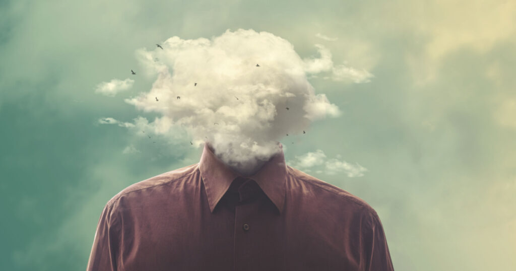 stressed man head in the cloud
