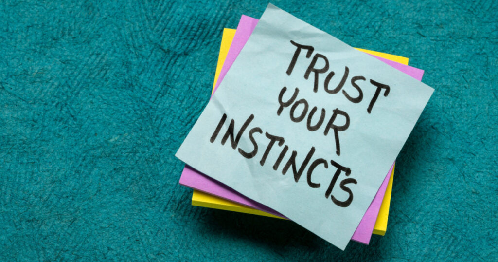 trust your instincts - advice or motivational reminder on a sticky note, confidence and personal development concept
