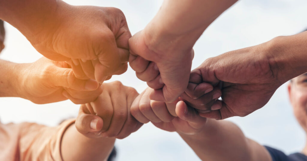 Close up hands Teamwork group of multi racial people meeting join hands. Diversity people hands join empower partnership teams connect volunteer community. Diverse multiethnic Partners team together
