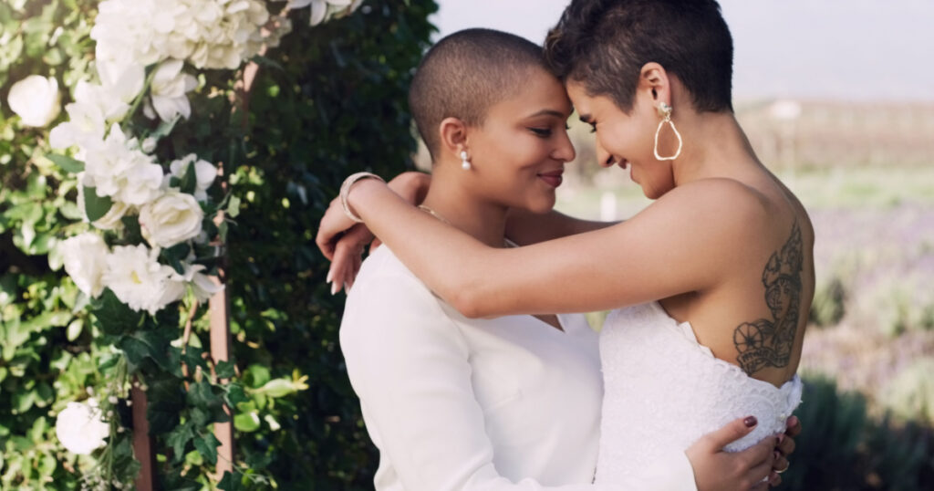 They find happiness in each other. an affectionate young lesbian couple standing with their arms around each other on their wedding day.
