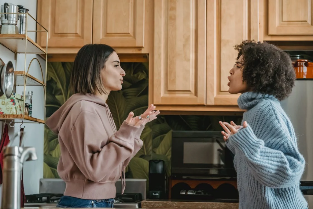 Multiethnic women having conflict in kitchen
