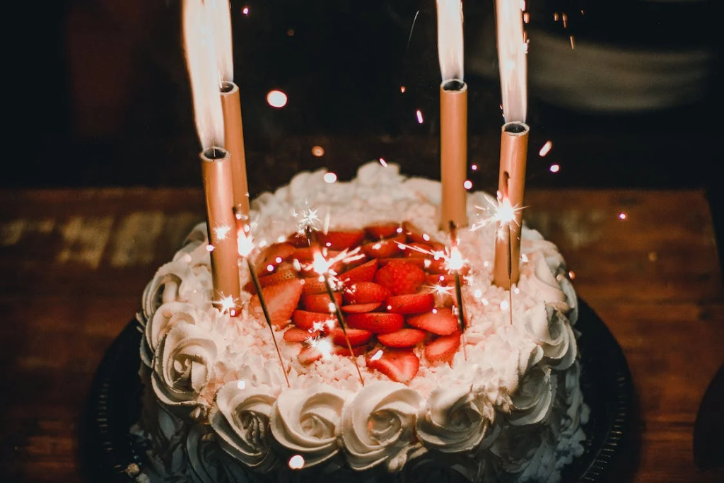Lit Candles on an Elegant Looking Cake
