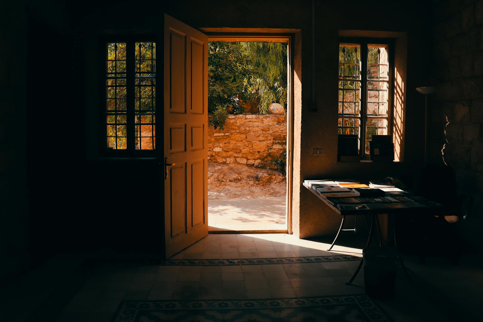 Warm sunlight streams through an open door in a traditional home interior in Amman, Jordan.