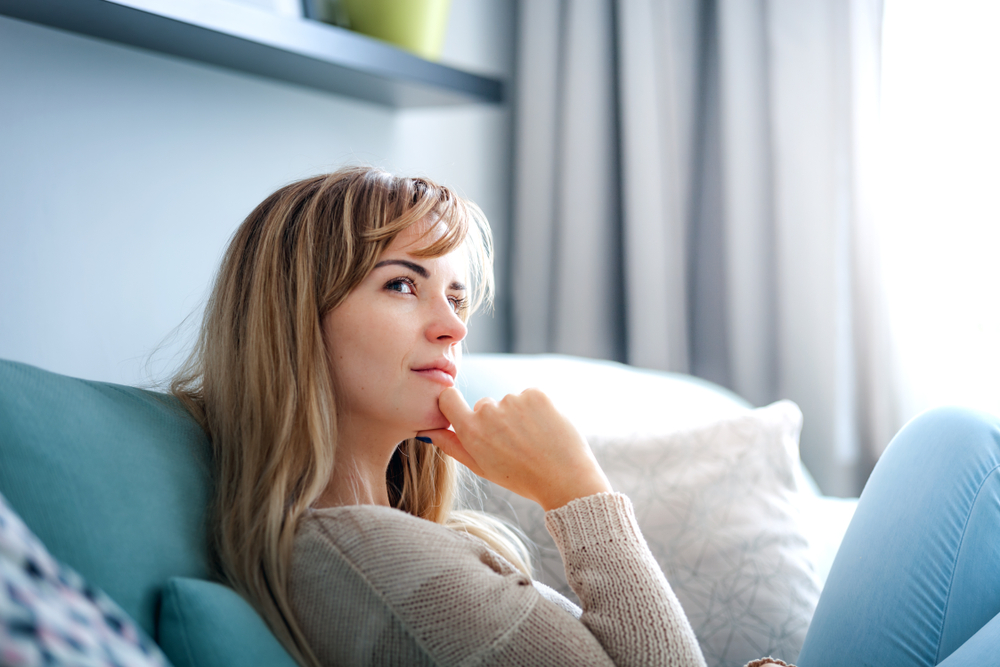 woman thinking sitting up in bed