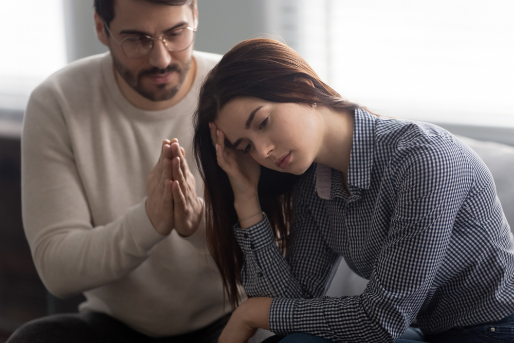 man apologizing to woman