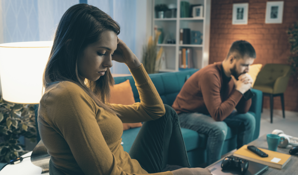 couple sitting together unhappy