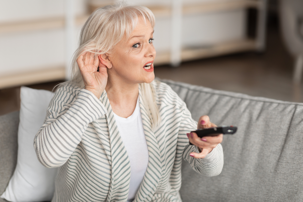 woman acting as if she can't hear over 50