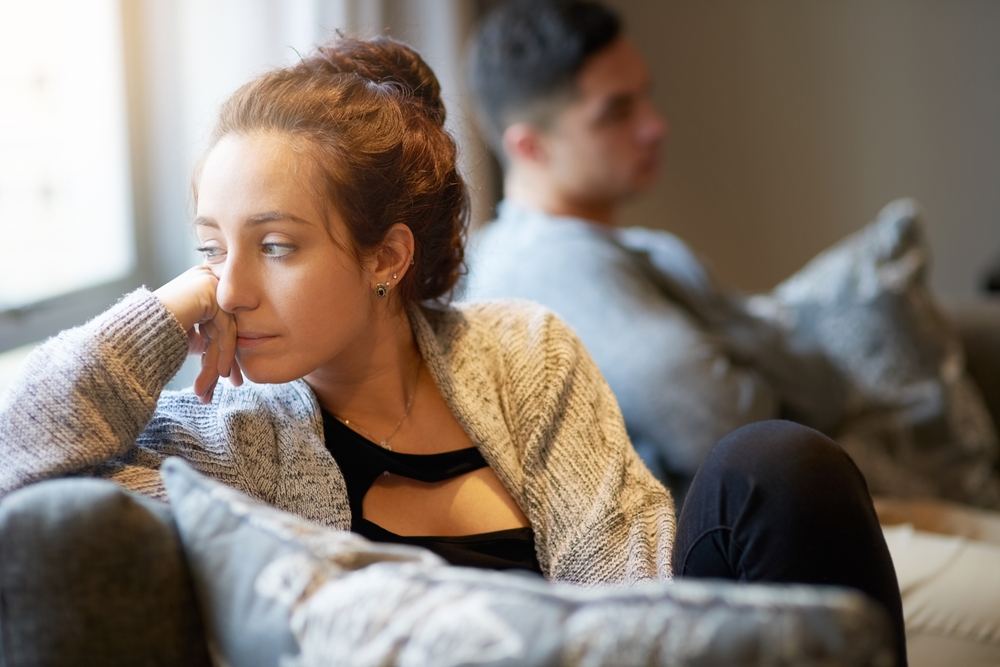 unhappy couple on couch