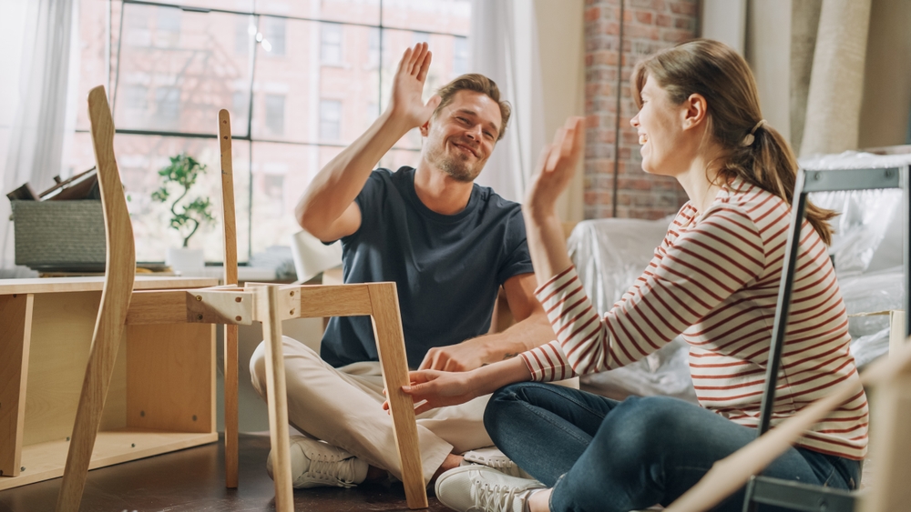 couple building furniture together