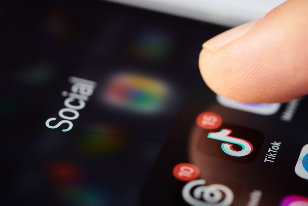 person using phone social media to avoid loneliness