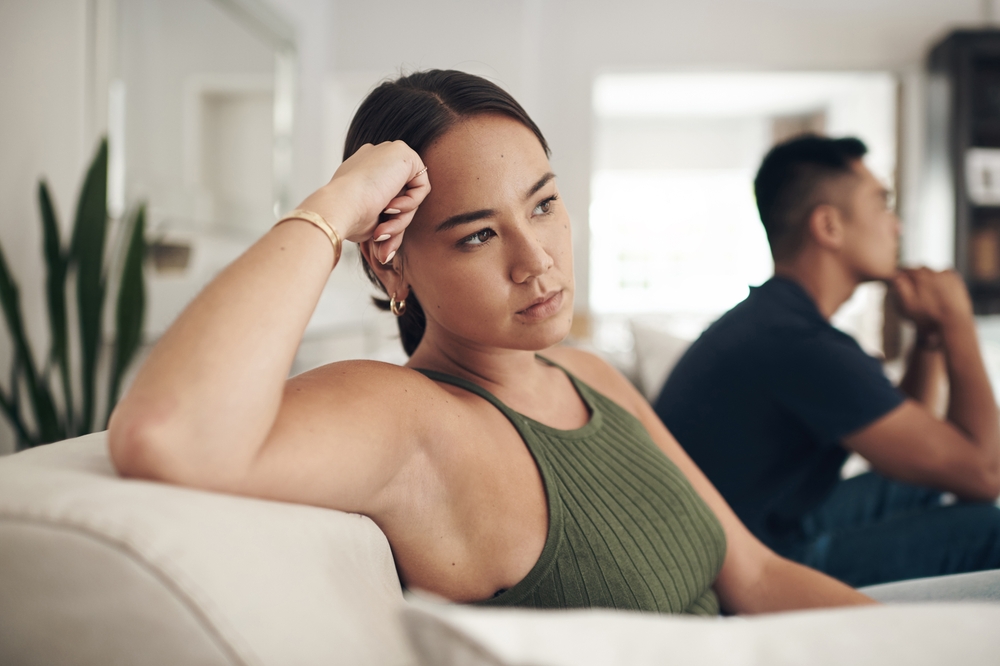 woman and man on couch unhappy couple