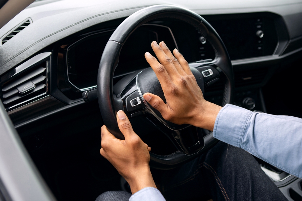 person honking car horn driving