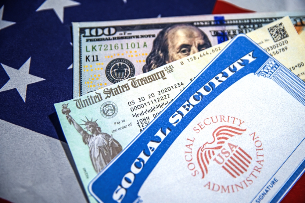 8.4.2025, United States. Social Security Card, U.S. Treasury Check and Dollar Bill concept placed on the American Flag, close up view background. People welfare, payout, relief, pension, ssn benefit
