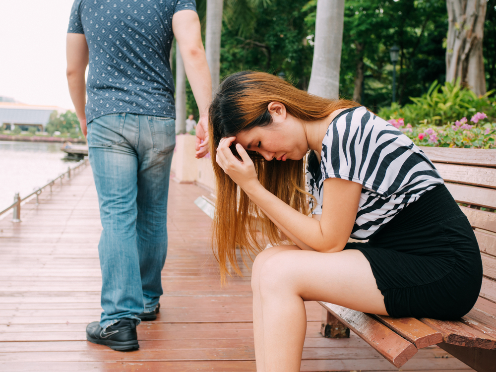 man walking away from woman after argument