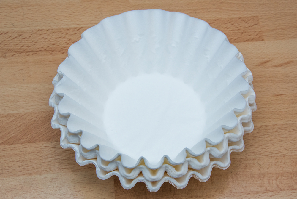 coffee filters in stack on wooden table