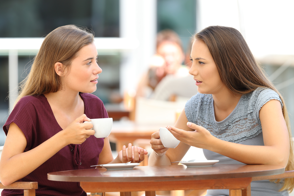 two women having a serious conversation