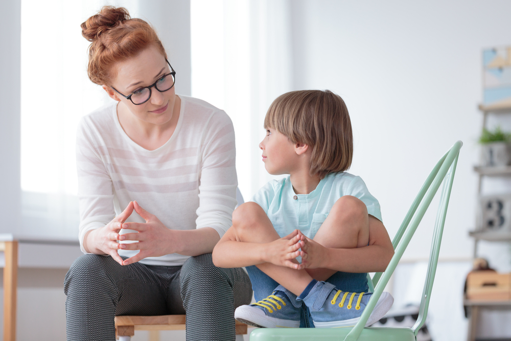 woman talking to child in room