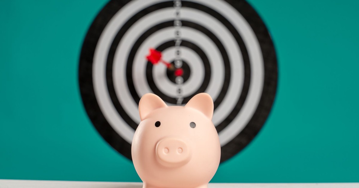 Piggy bank with bullseye dart board symbolizing financial goals and savings.