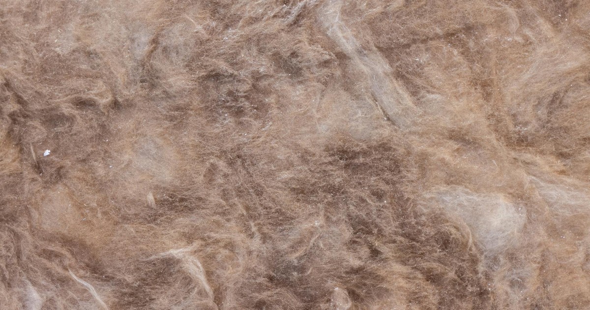 Detailed close-up view of brown wool texture, ideal for backgrounds.