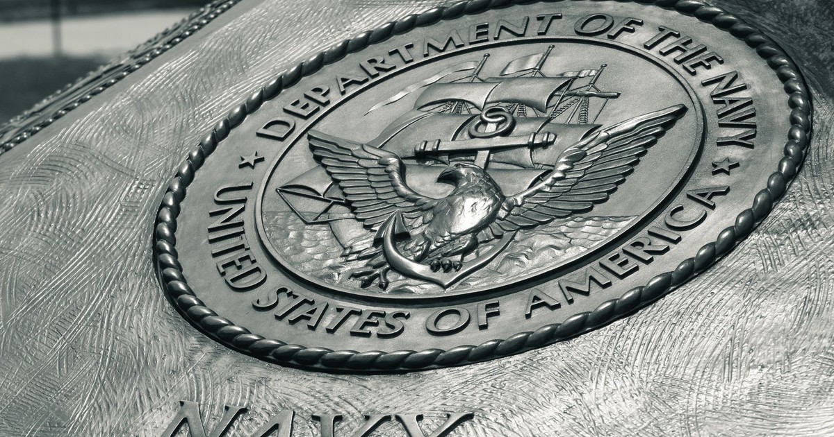 Detailed view of the United States Navy emblem on a monument in Washington D.C., showcasing naval heritage.