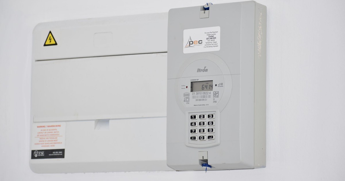 Electrical meter and fuse box on a white wall in Cape Town, South Africa, for energy monitoring or billing.