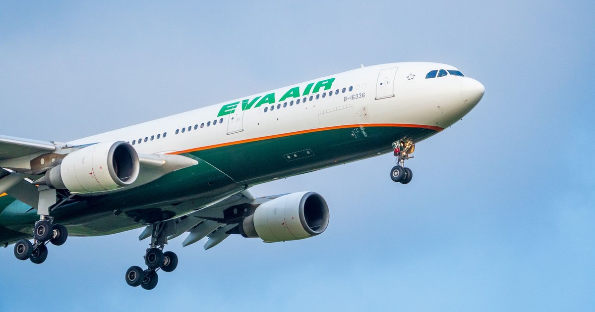 EVA Air Airbus A330 flying against a clear blue sky with landing gear down.