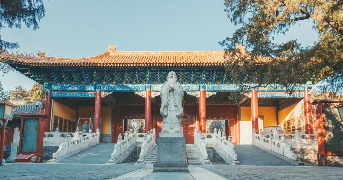 A picturesque view of a traditional Chinese temple with a prominent statue in Beijing, China.
