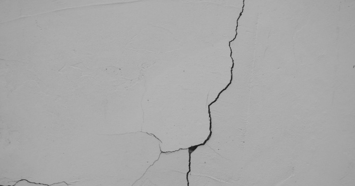 a crack in the side of a white wall