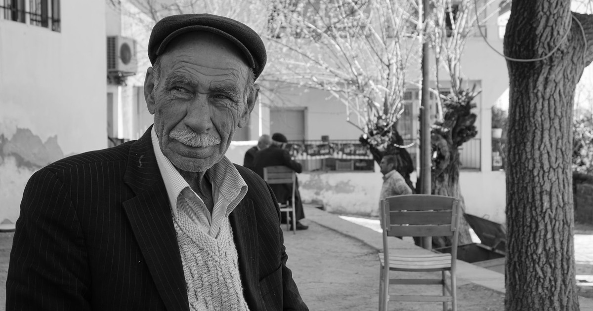 Portrait of an elderly man with a mustache in Çomakdağ, Türkiye. Captivating black and white street photography.