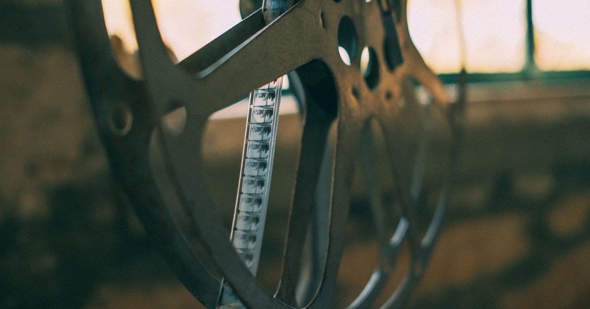 Artistic shot of a vintage film reel with soft light creating a nostalgic atmosphere.