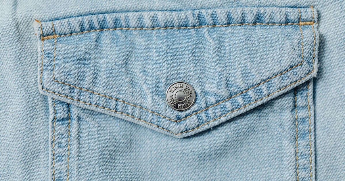 A detailed view of a stylish denim pocket showcasing stitch work and texture.