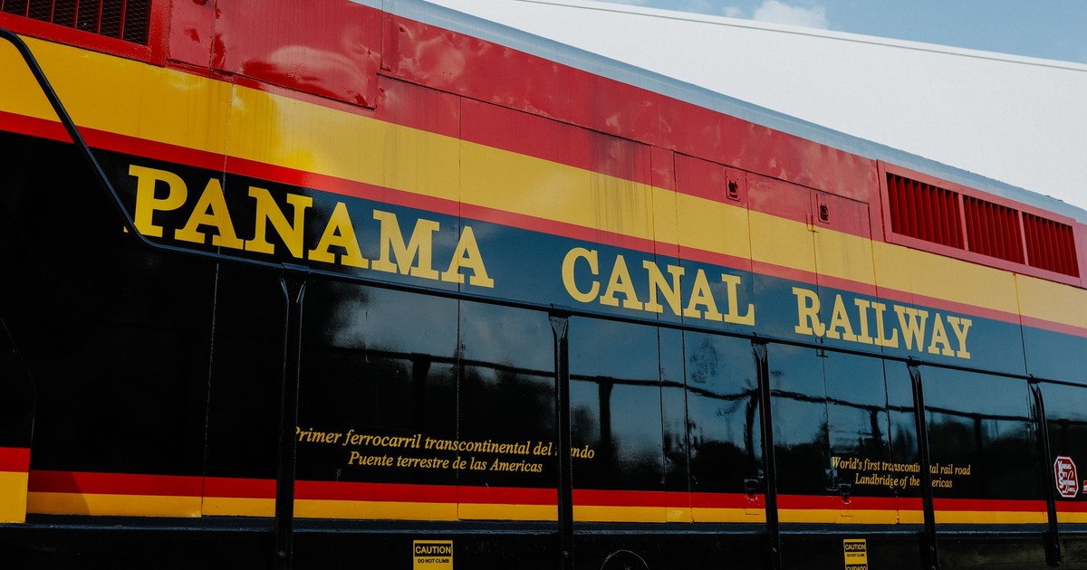 Close-up view of Panama Canal Railway train displaying vibrant colors and signage.