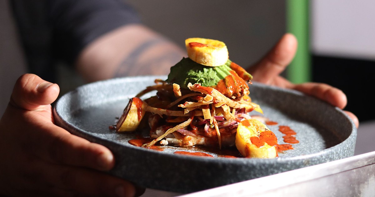 A delicious gourmet meal featuring plantains and sauce, elegantly plated and ready to serve.