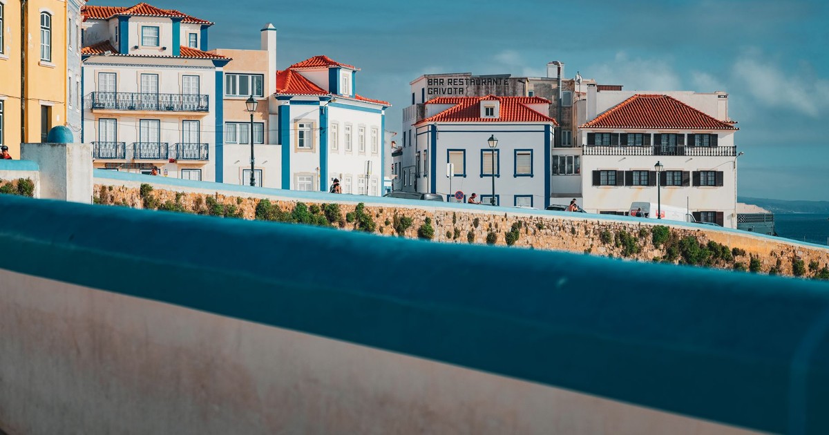 Captivating coastal architecture in Ericeira, Lisbon, showcasing colorful facades and vibrant rooftops.